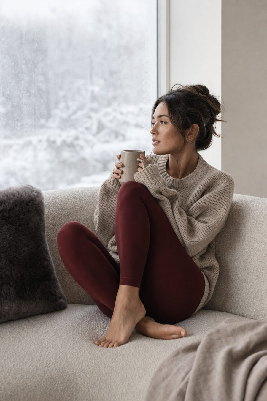 Wine red leggings with a knit sweater at home